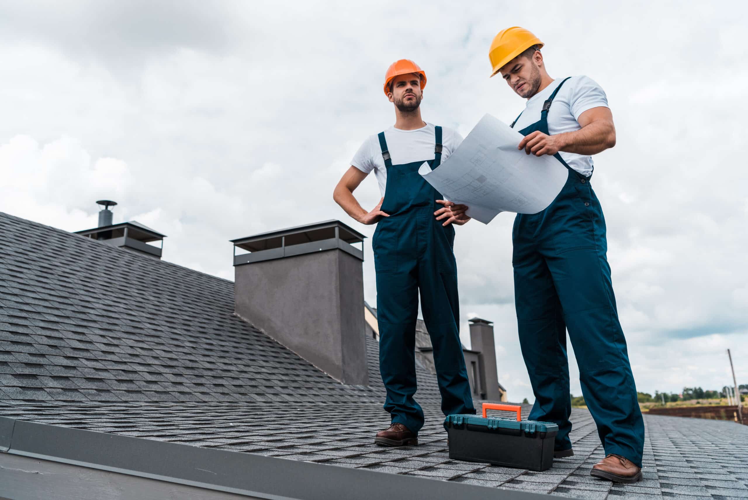 architect standing on roof with hands on hips near 2024 11 18 00 05 27 utc scaled - roof assessment - 12 Stones Roofing