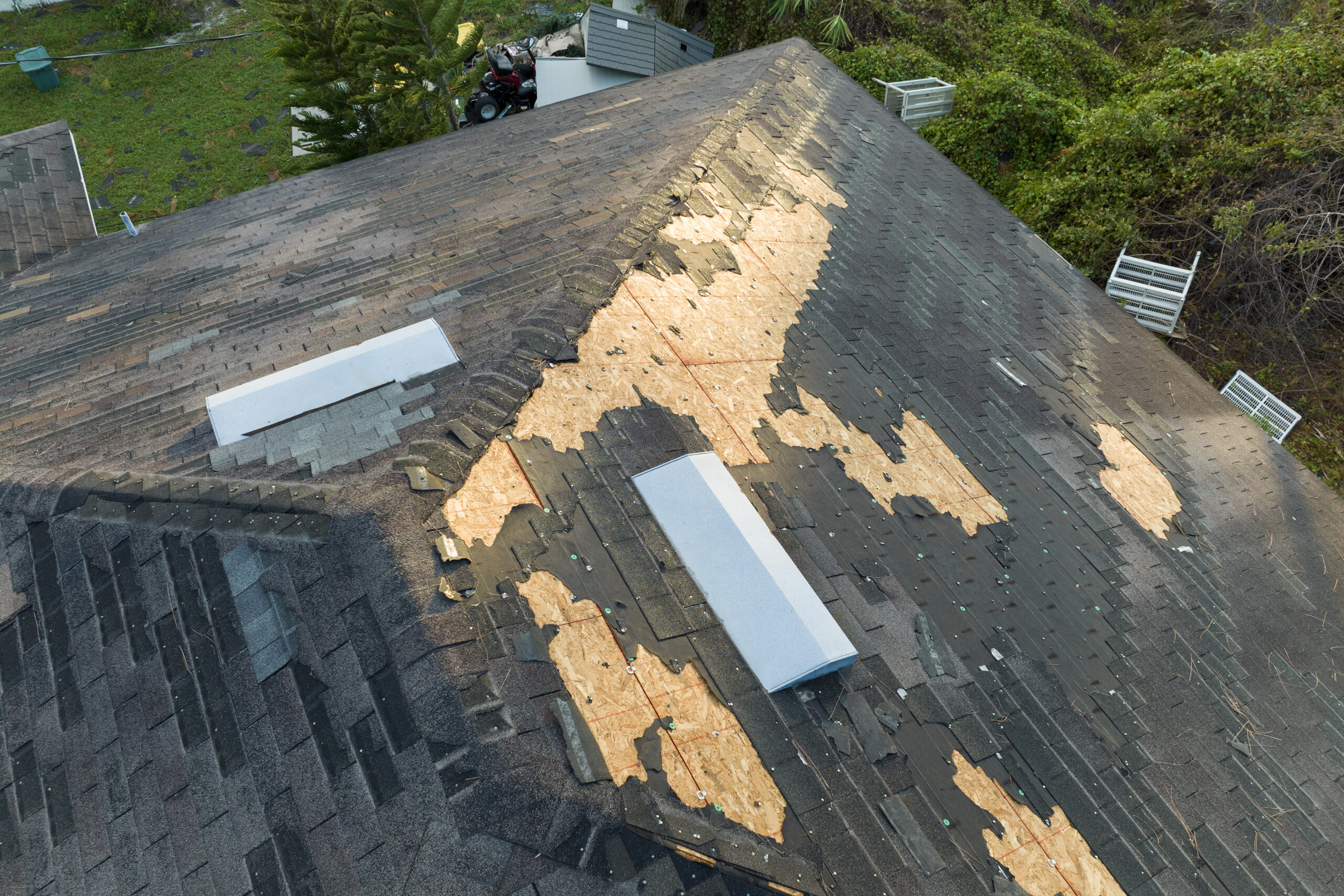 damaged house roof with missing shingles after hur 2024 12 07 03 39 46 utc scaled - 12 Stones Roofing