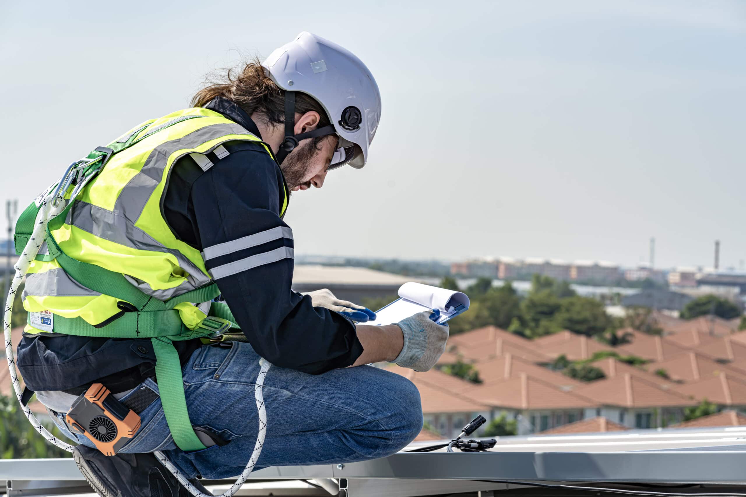 Male engineer performing roof assessment