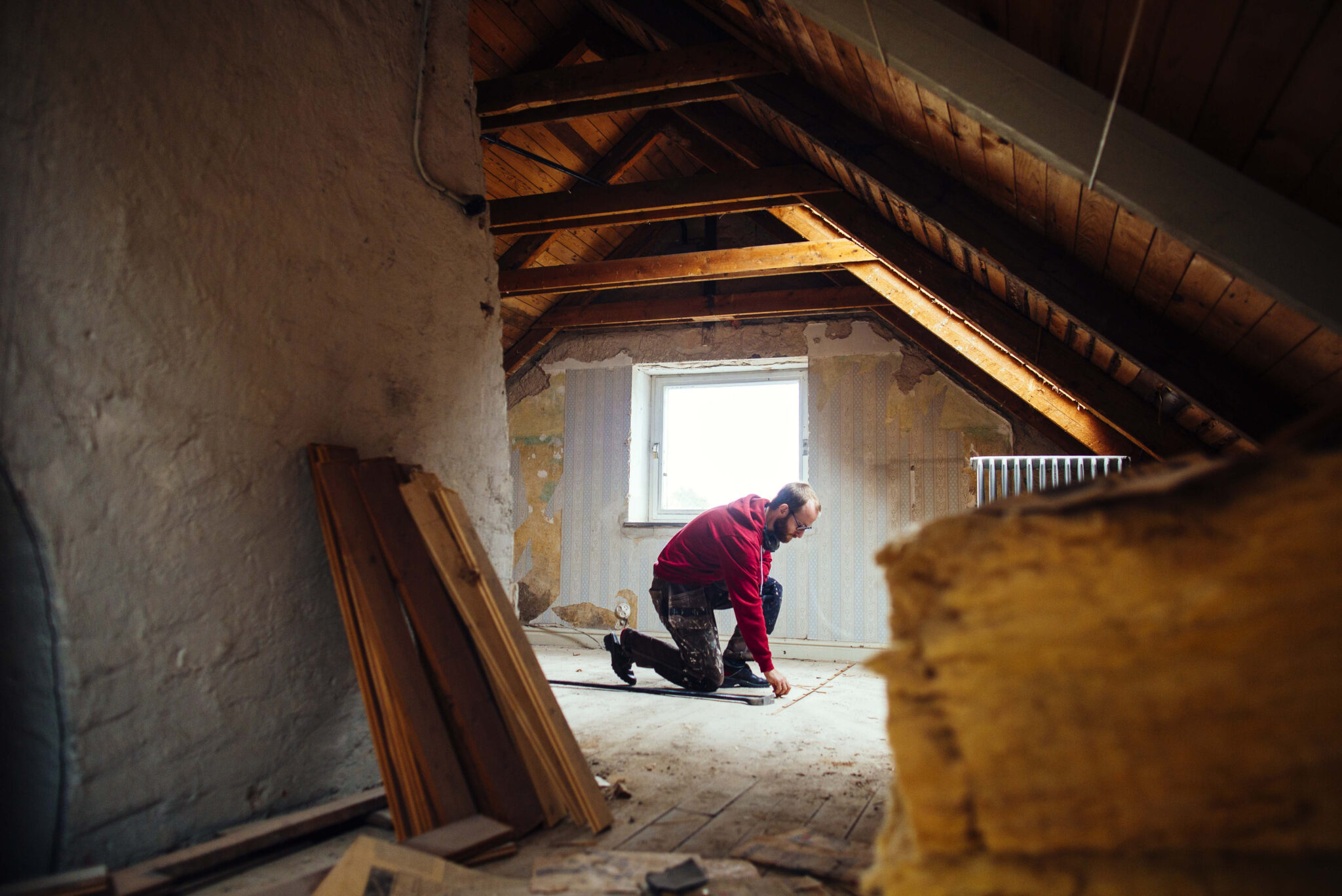 mid adult man marking on floor in attic under reno 2024 10 11 13 14 08 utc - 12 Stones Roofing