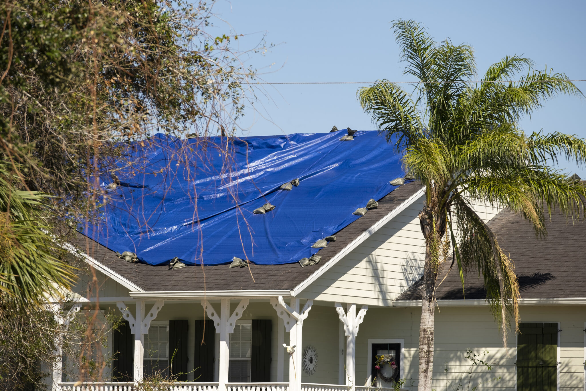 damaged in hurricane house roof covered with blue 2024 12 06 05 01 07 utc - storm damage - 12 Stones Roofing