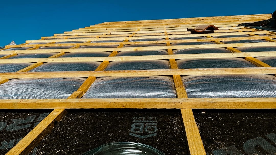 TPO roofing membrane roll installation on commercial flat roof